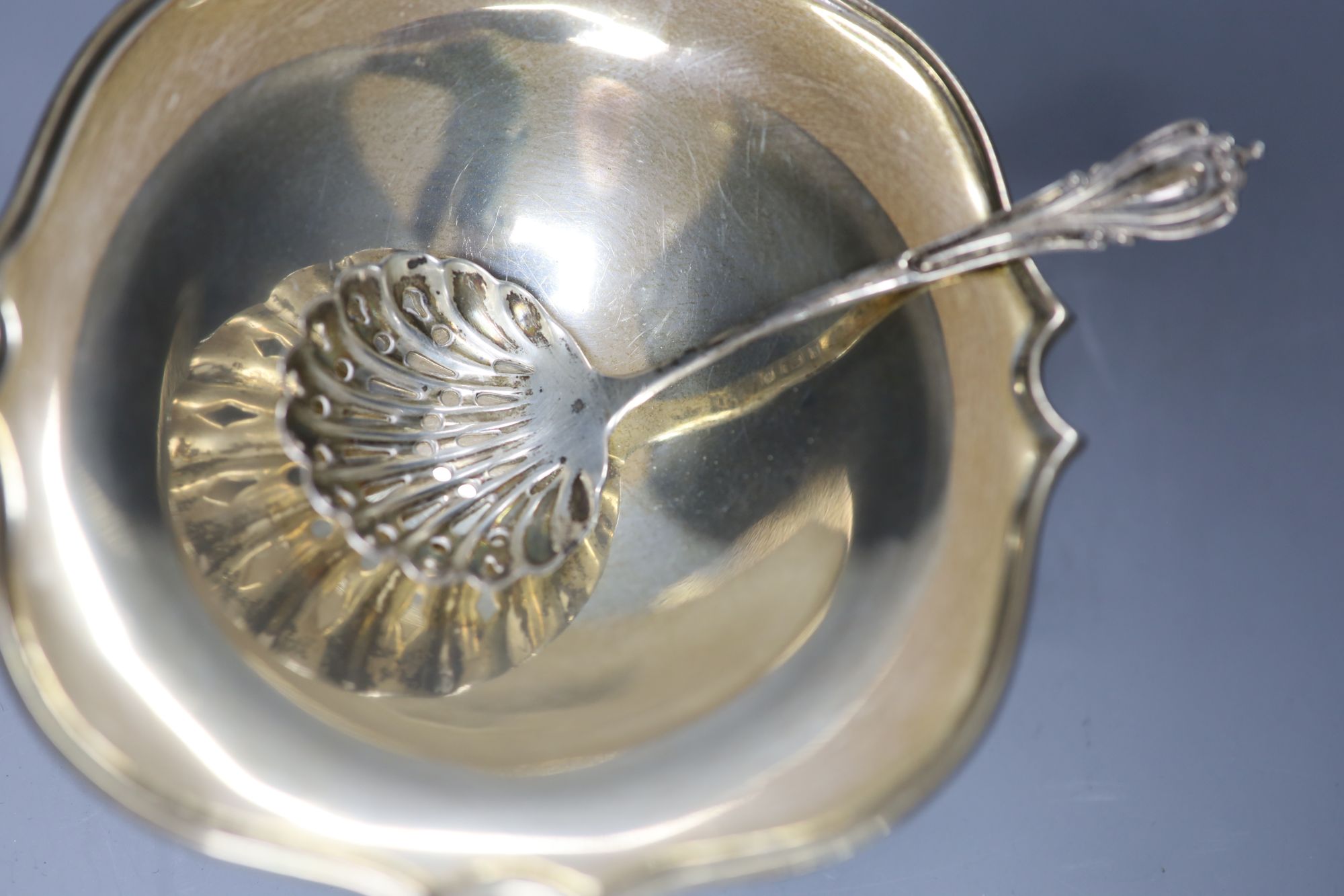 A silver shaped square small pedestal bowl, a silver spiral-fluted cream jug and a silver sifter spoon, gross 5.18oz.